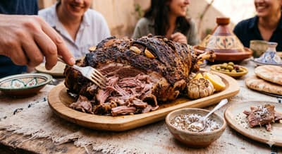 Roasted lamb shoulder with herbs on a serving board